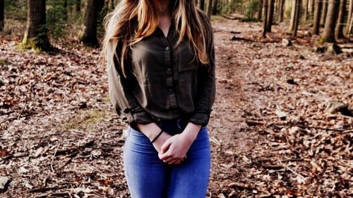 Woman standing in forest