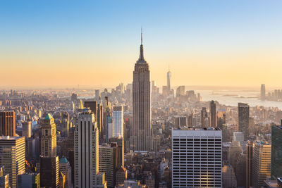 Aerial view of buildings in city during sunset