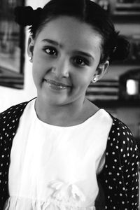 Portrait of smiling girl standing at home
