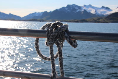 Close-up of rope tied on boat sailing in sea