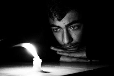 Portrait of young man in darkroom