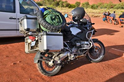 Motor cycle parked near car