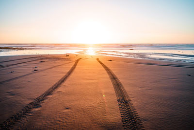 Scenic view of beach against sky during sunset