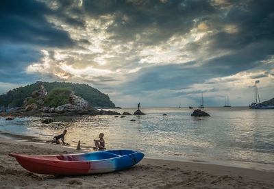Boats on beach against sky