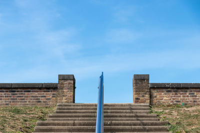 Low angle view of staircase against blue sky