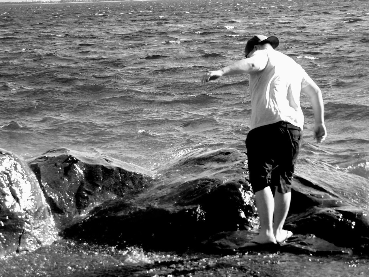 real people, sea, water, one person, standing, beach, full length, wave, splashing, sand, lifestyles, leisure activity, outdoors, rear view, day, motion, men, vacations, nature, one man only, adults only, adult, people