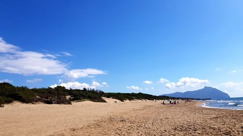 Panoramic view of beach against blue sky