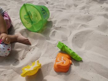 High angle view of hand holding toy on beach