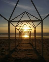 Pier on sea at sunset