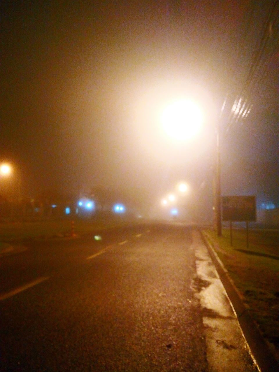 illuminated, the way forward, night, transportation, street light, road, street, diminishing perspective, lighting equipment, vanishing point, road marking, empty, wet, built structure, city, empty road, architecture, lens flare, building exterior, light - natural phenomenon