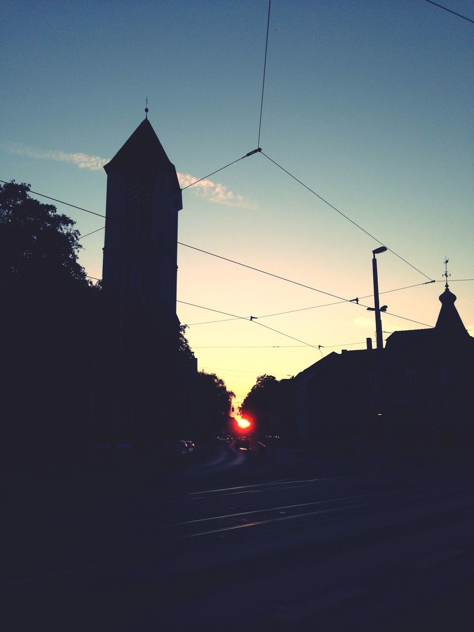 built structure, architecture, building exterior, sunset, silhouette, clear sky, sun, low angle view, sky, sunlight, outdoors, no people, dusk, road, copy space, street, religion, lens flare, church, nature