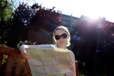 Woman reading map in city