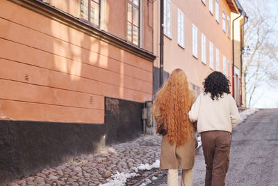 Rear view of women walking in street