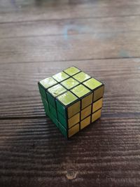High angle view of puzzle cube on wooden table