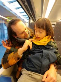 Portrait of young man with a child sitting at the train