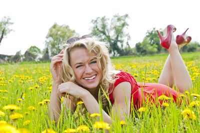 Portrait of smiling woman on grassy field
