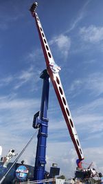 Low angle view of crane against sky