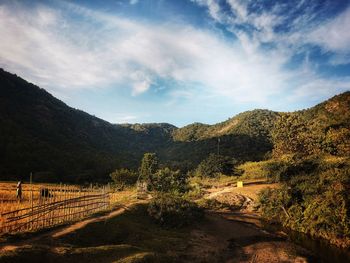 Scenic view of landscape and mountains against sky