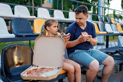 Father and daughter watching soccer match