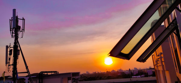 Silhouette street against sky during sunset