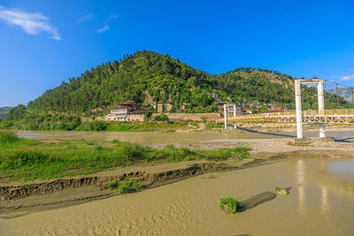 Scenic view of landscape against blue sky