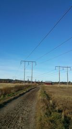 View of country road against clear blue sky