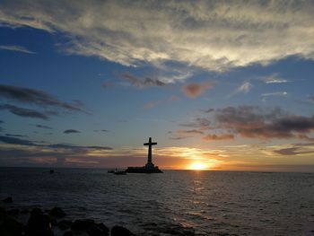 Scenic view of sea against cloudy sky