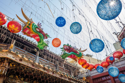 Low angle view of lanterns hanging on ceiling of building