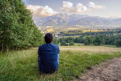 Rear view of man looking at mountains