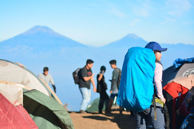 Girl with the big backpack on the mountain