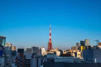 Buildings in city against blue sky