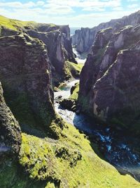 Scenic view of river amidst rocks against sky