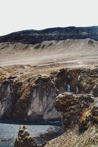 Scenic view of cliff by sea