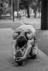 Young man stretching outdoors