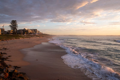 Scenic view of beach against sky during sunset