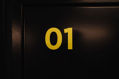 Close-up of number on black door