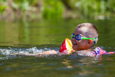 Portrait of boy swimming in lake