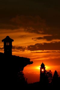 Silhouette temple against sky during sunset