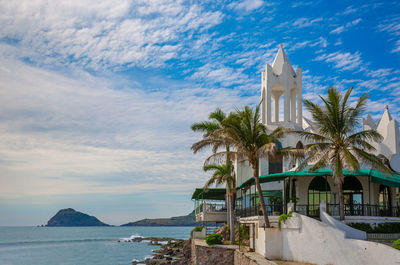 View of building by sea against sky