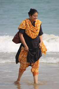 Woman walking on shore at beach
