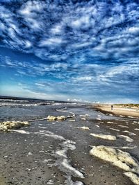 Scenic view of beach against blue sky