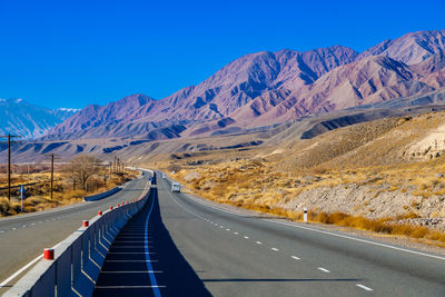 Empty road against mountain