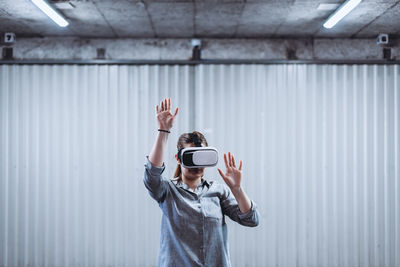 Woman with vr goggles enjoying virtual reality experience