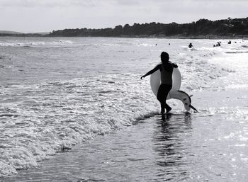 Full length of man on beach against sky