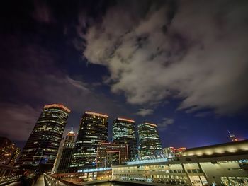 Illuminated buildings against sky at night