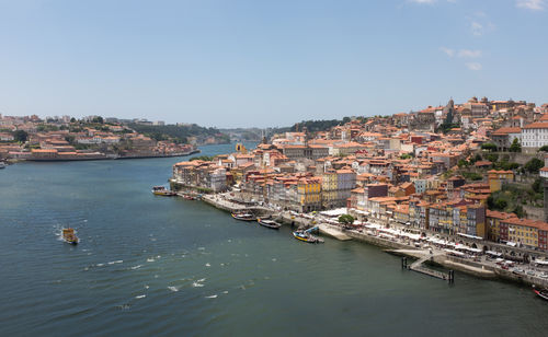 High angle view of townscape by sea against sky