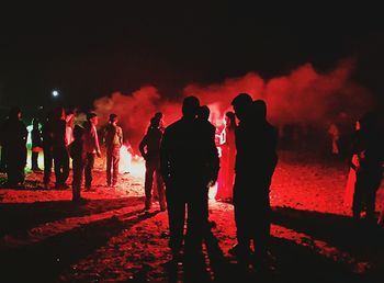 People burning fireworks at night