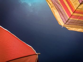 Low angle view of red umbrella against sky