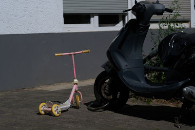 Toy car against wall in city