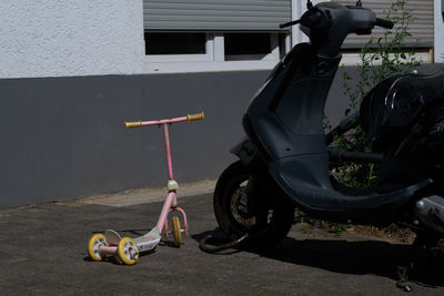 Toy car against wall in city